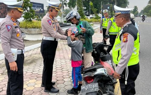 Dirlantas Polda Riau Bagikan Helm Gratis pada Pengendara Sepeda Motor